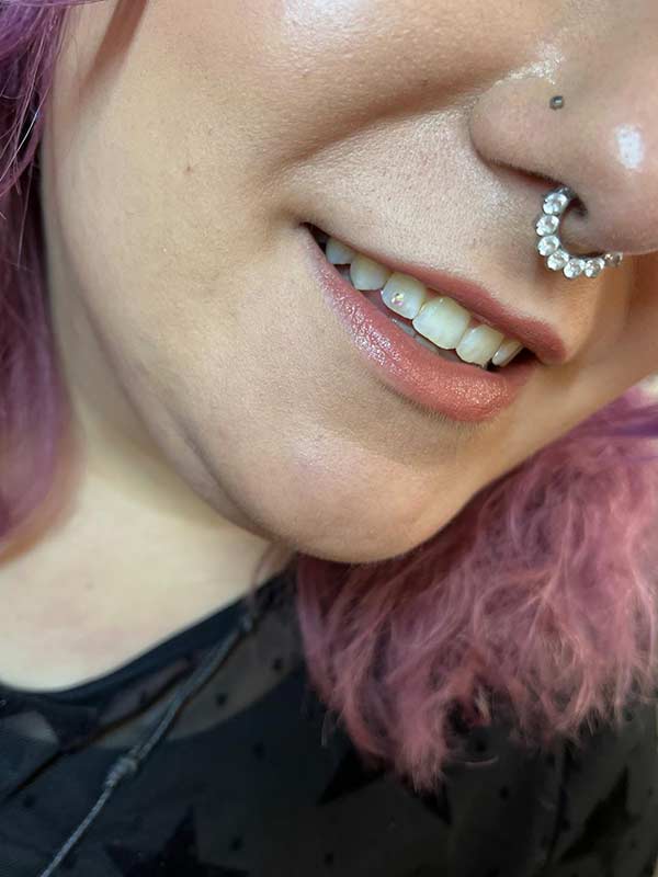 A client with Charmed Smile tooth gems